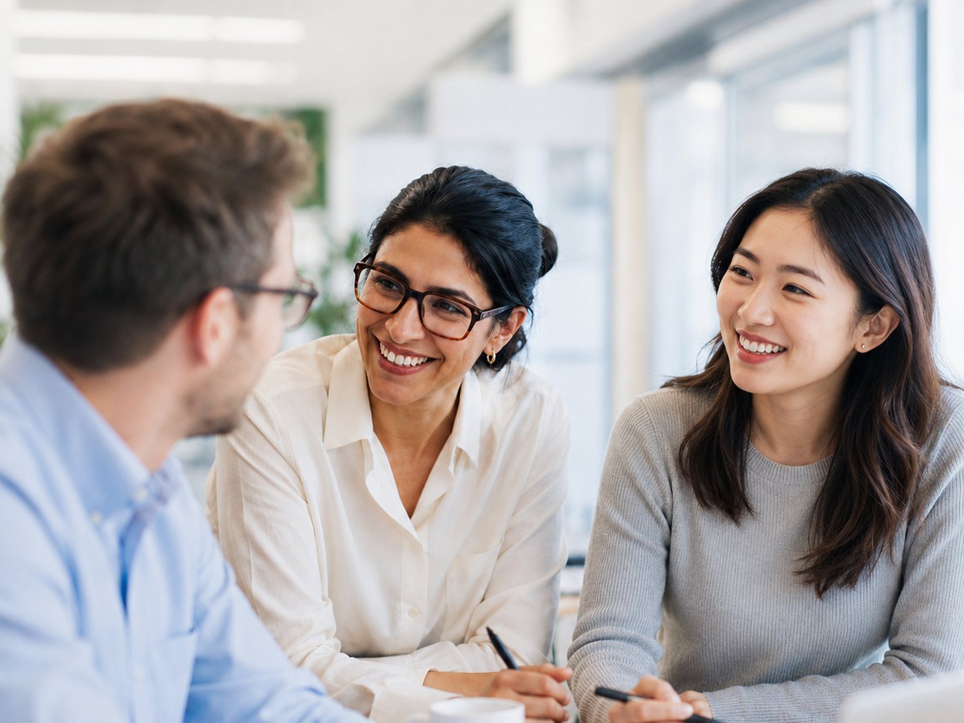 Three colleagues in discussion at a table